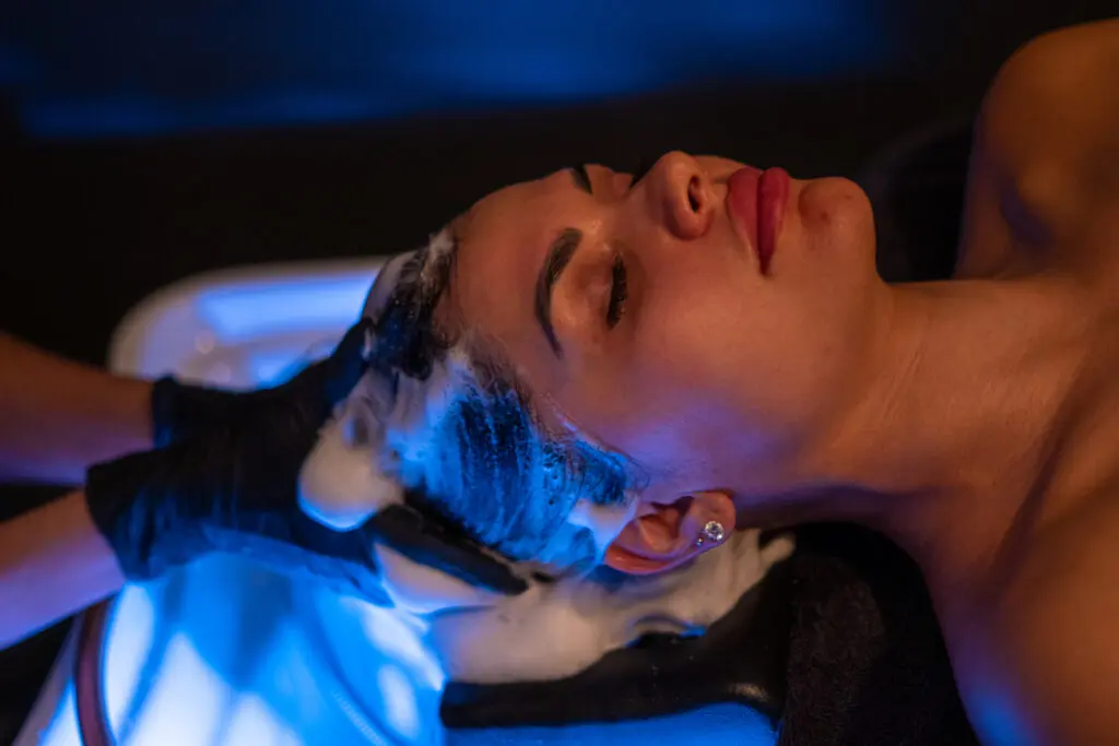 Client receiving a relaxing scalp massage